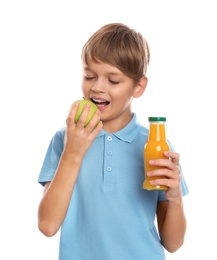 Photo of Little boy with bottle of juice and apple on white background. Healthy food for school lunch