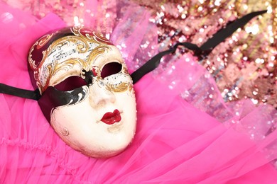 Photo of Carnival mask and beautiful pink costume with sequins, above view