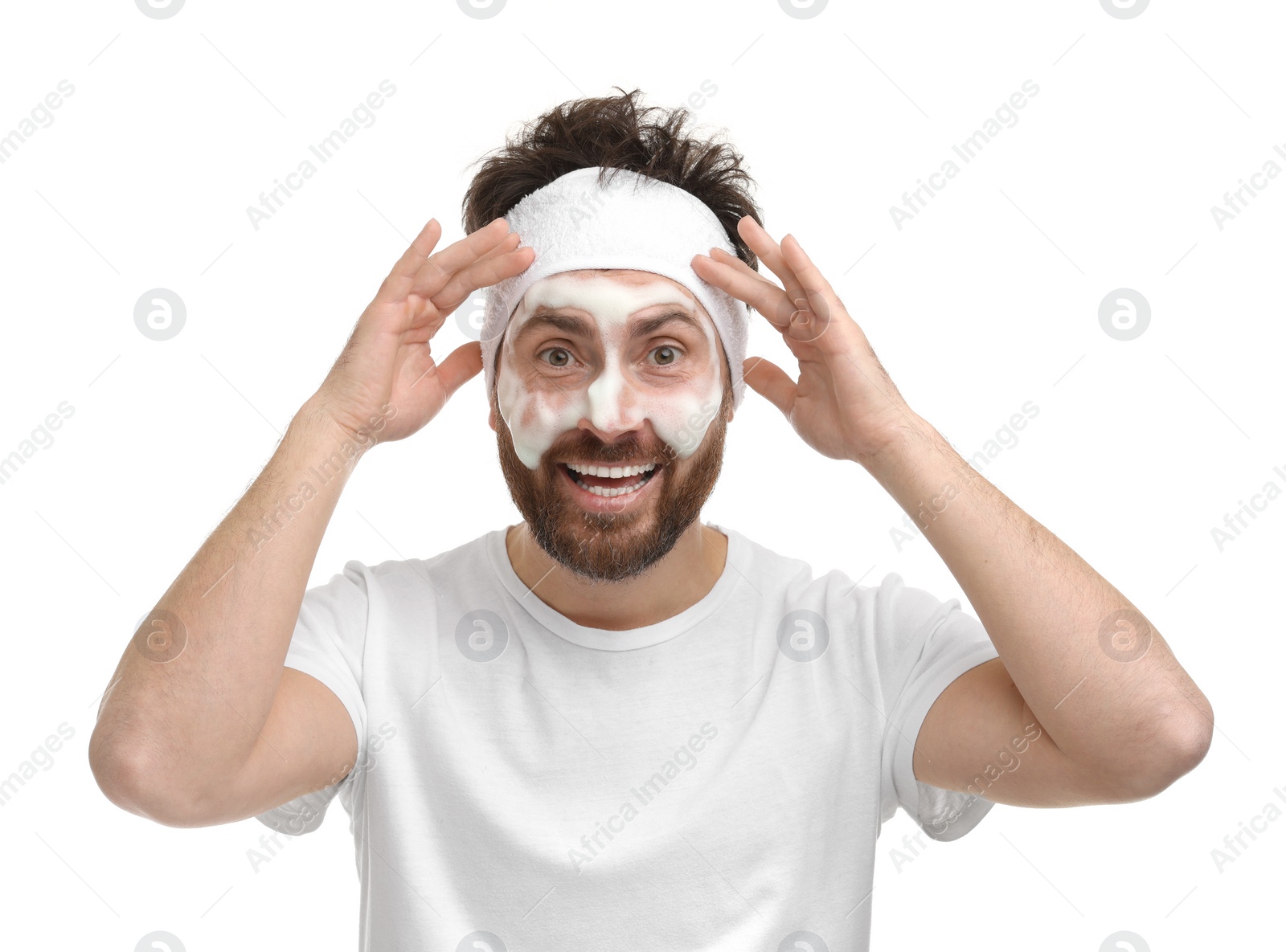 Photo of Emotional man with headband washing his face on white background