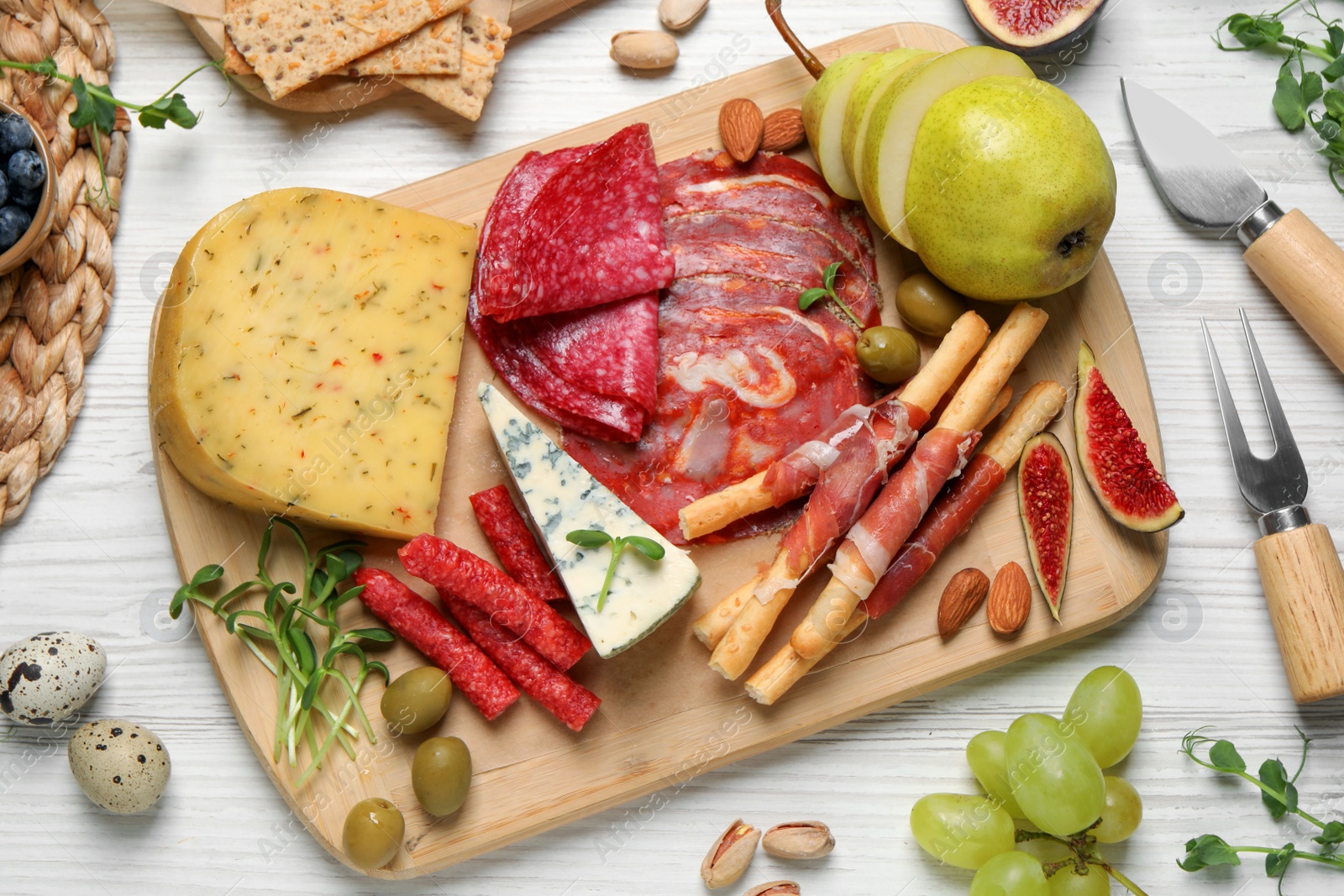 Photo of Set of different delicious appetizers served on white wooden table, flat lay