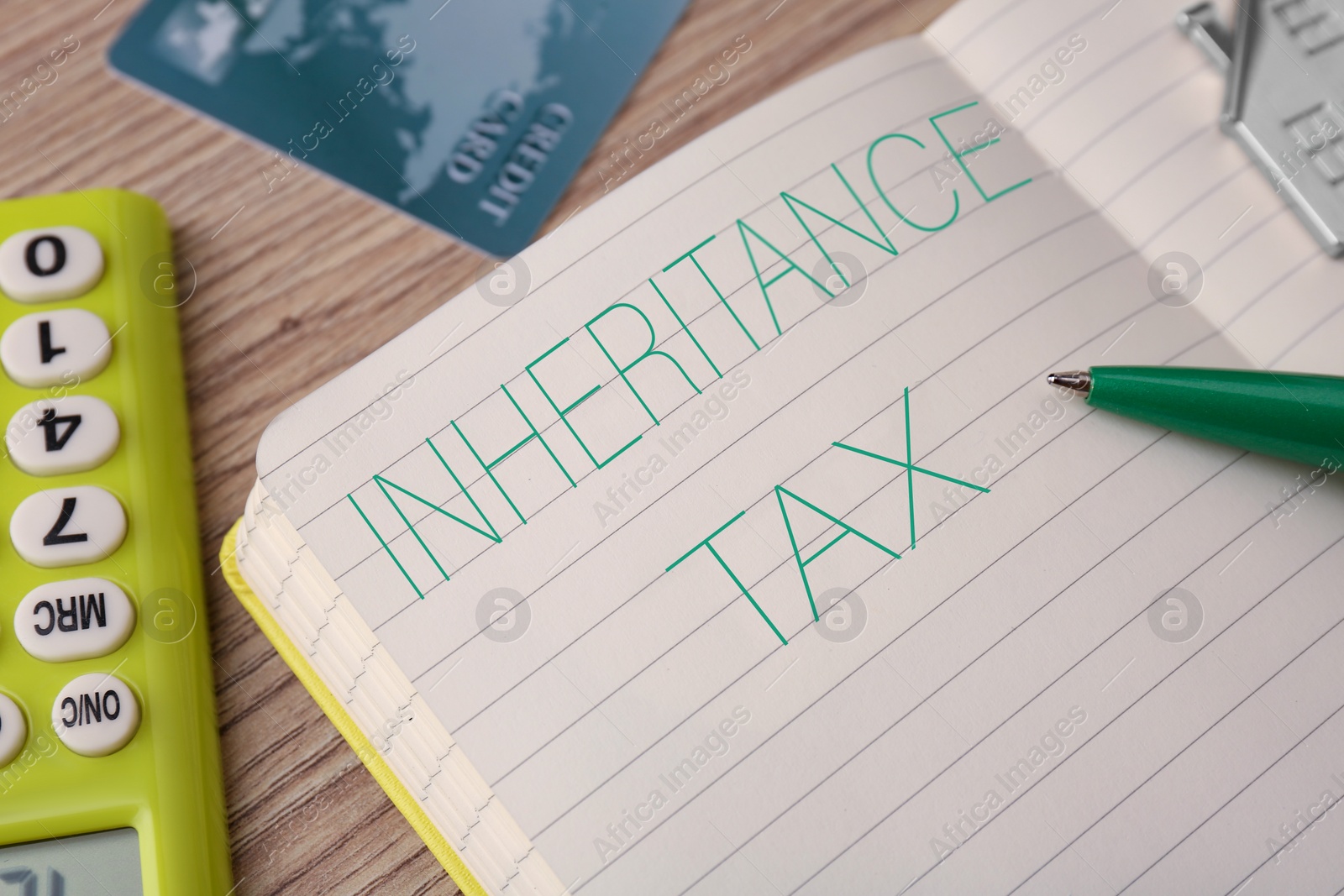 Photo of Notepad with phrase Inheritance Tax on wooden table, closeup