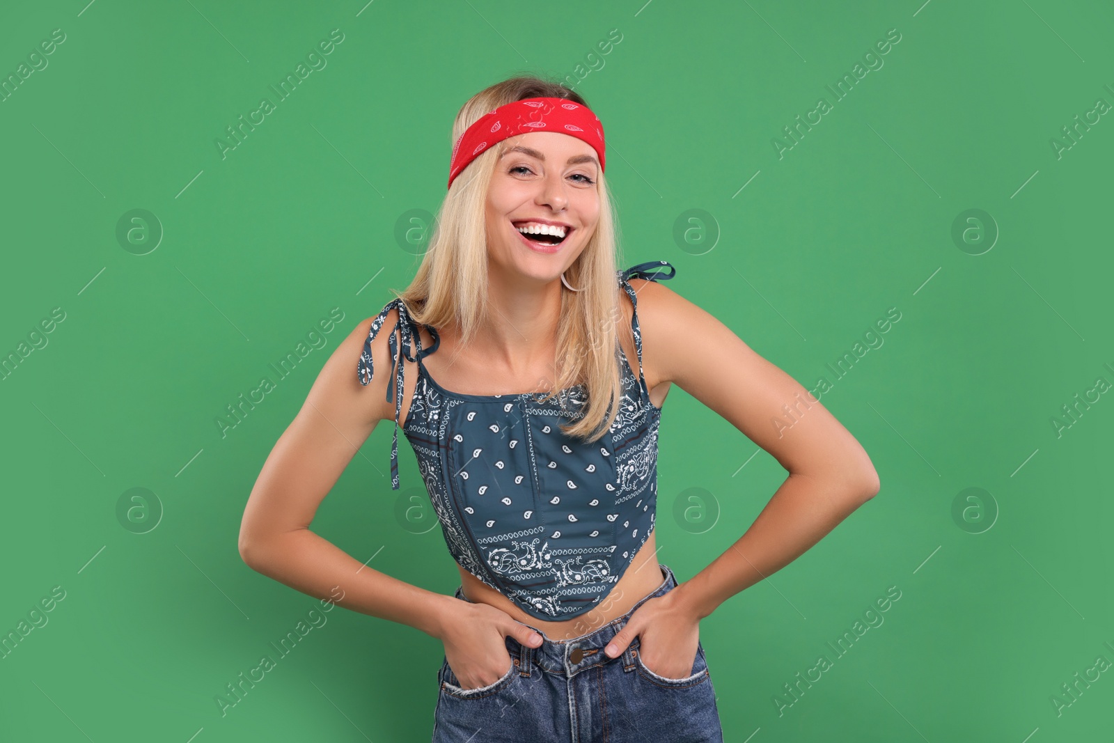 Photo of Portrait of happy hippie woman on green background