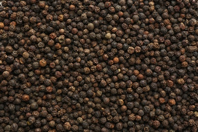Photo of Black pepper corns as background. Natural spice