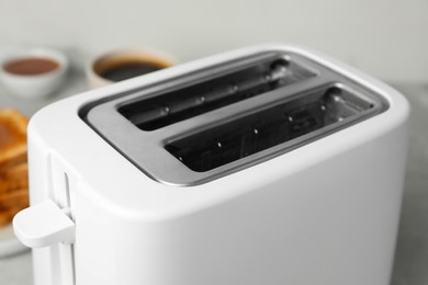 Photo of Closeup view of toaster indoors. Kitchen appliance