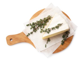 Board with piece of tasty camembert cheese and thyme isolated on white, top view
