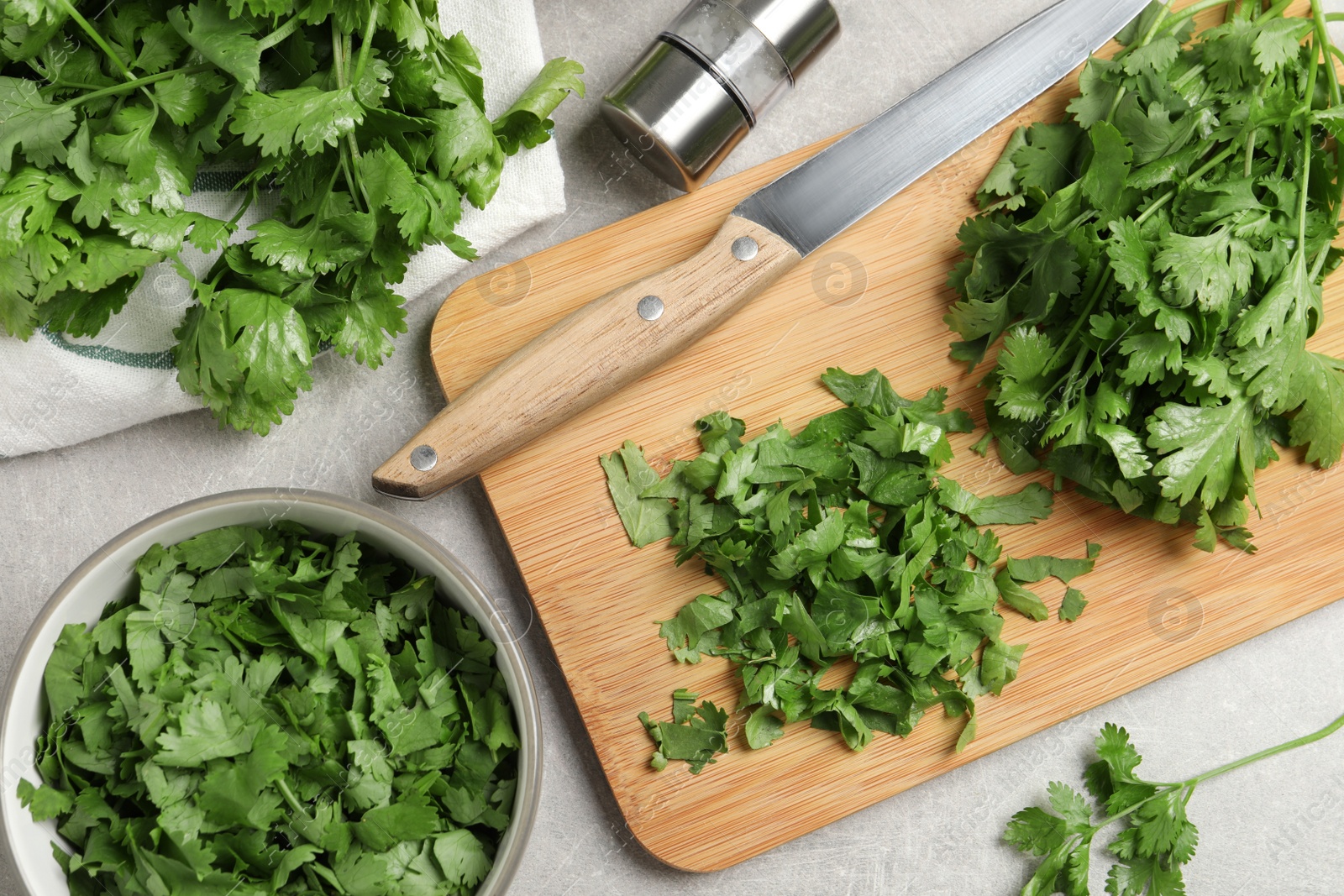 Photo of Fresh green cilantro on light grey table, flat lay