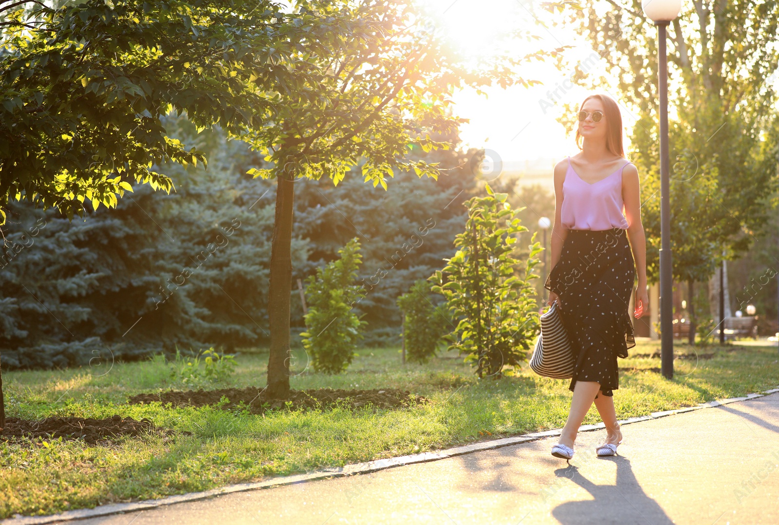 Photo of Beautiful young woman in park on sunny day