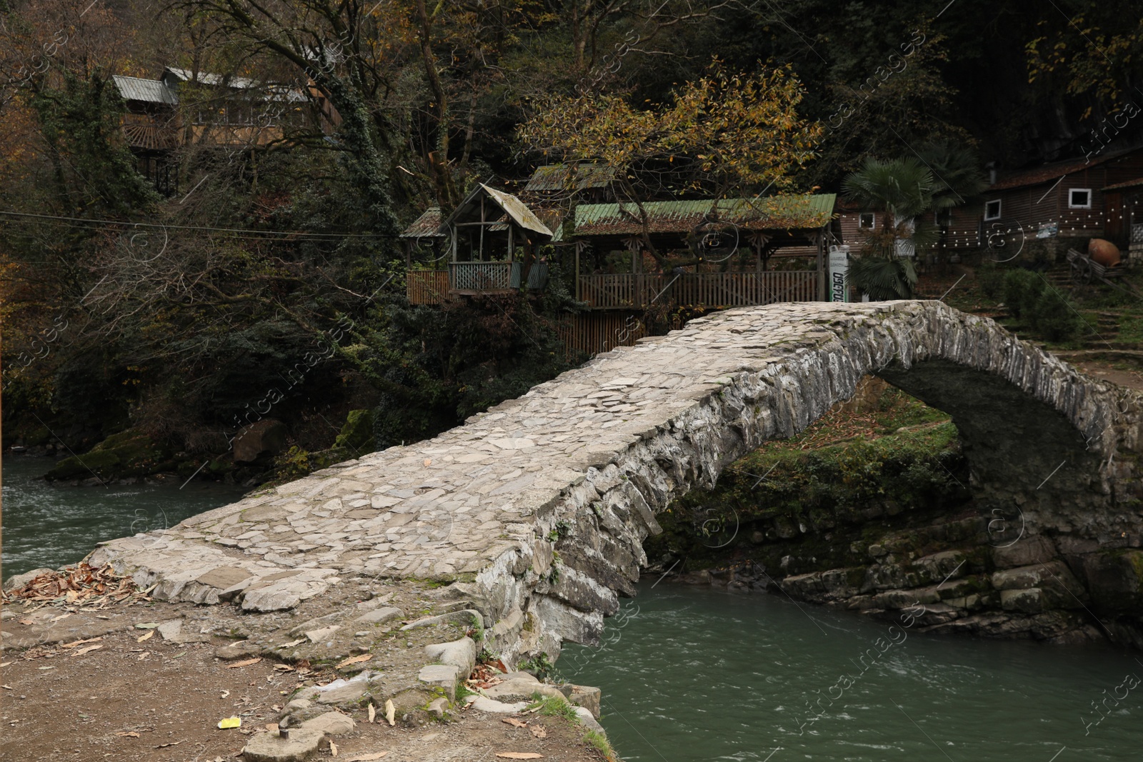 Photo of Adjara, Georgia - November 19, 2022: Picturesque view of stone arched bridge over Acharistskali river