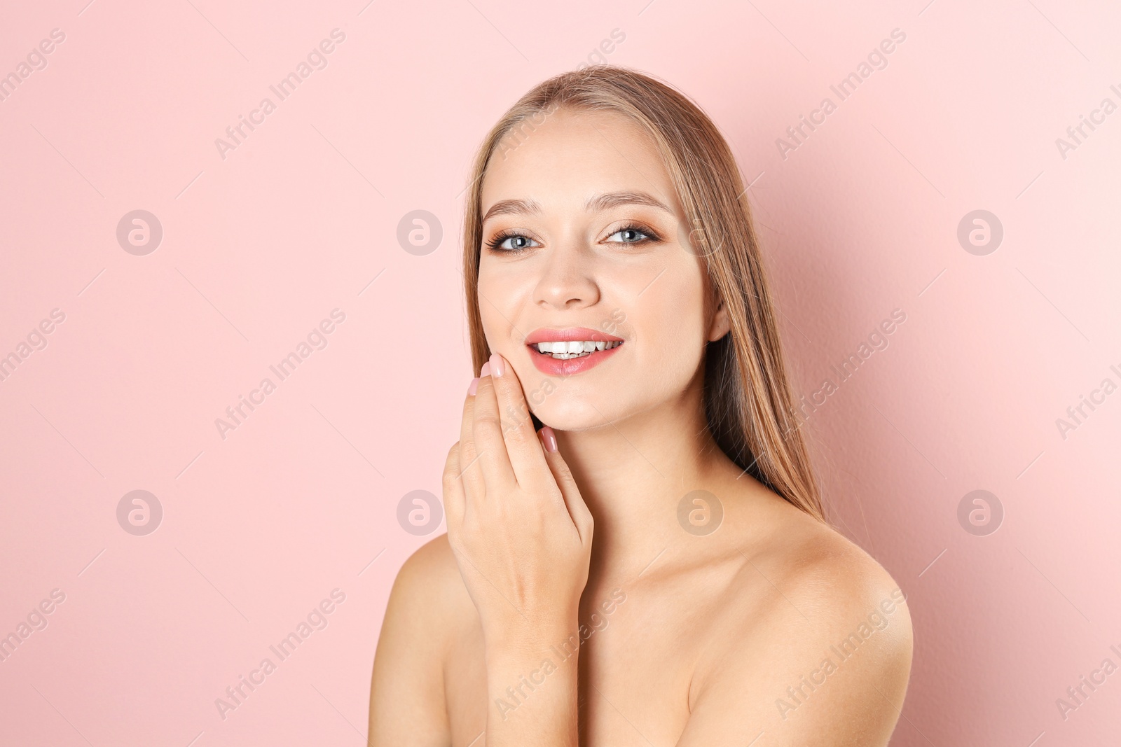 Photo of Portrait of beautiful young woman with natural makeup on color background
