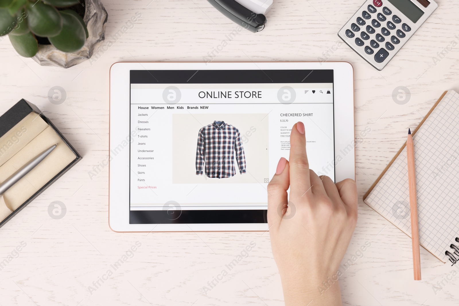 Photo of Woman with tablet shopping online at white wooden table, top view