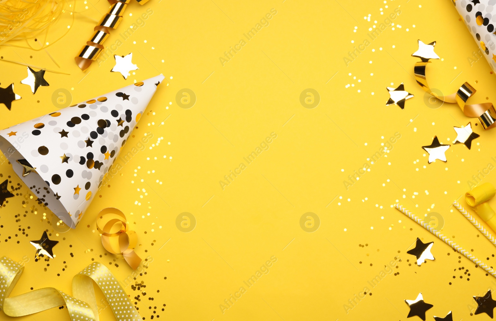 Photo of Flat lay composition with birthday decor on yellow background. Space for text