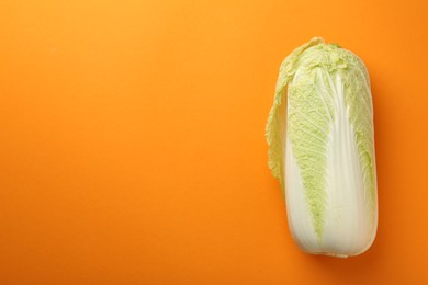 Photo of Fresh ripe Chinese cabbage on orange background, top view. Space for text