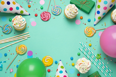 Photo of Flat lay composition with cupcakes on light green background, space for text. Birthday party