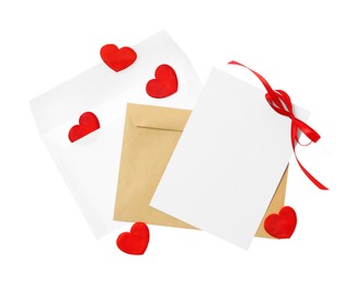 Blank card with red bow, envelopes and red decorative hearts on white background, top view. Valentine's Day celebration