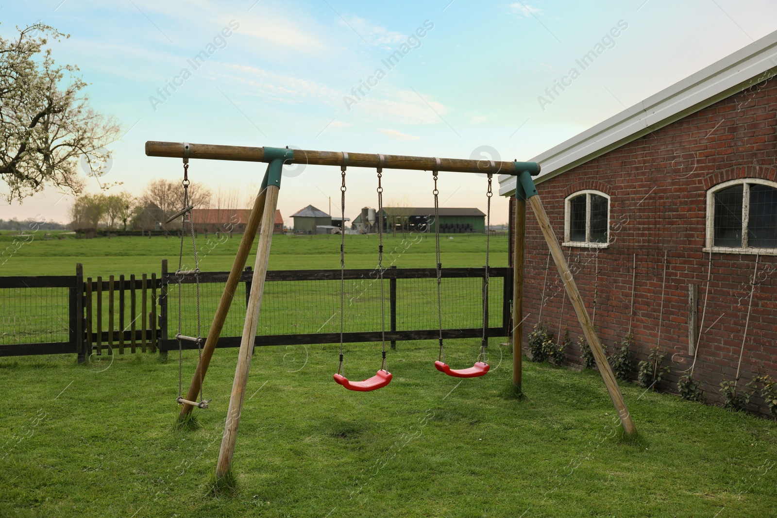 Photo of Spacious backyard with swing set in early morning
