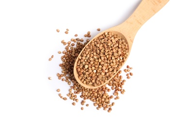 Spoon with uncooked buckwheat on white background, top view