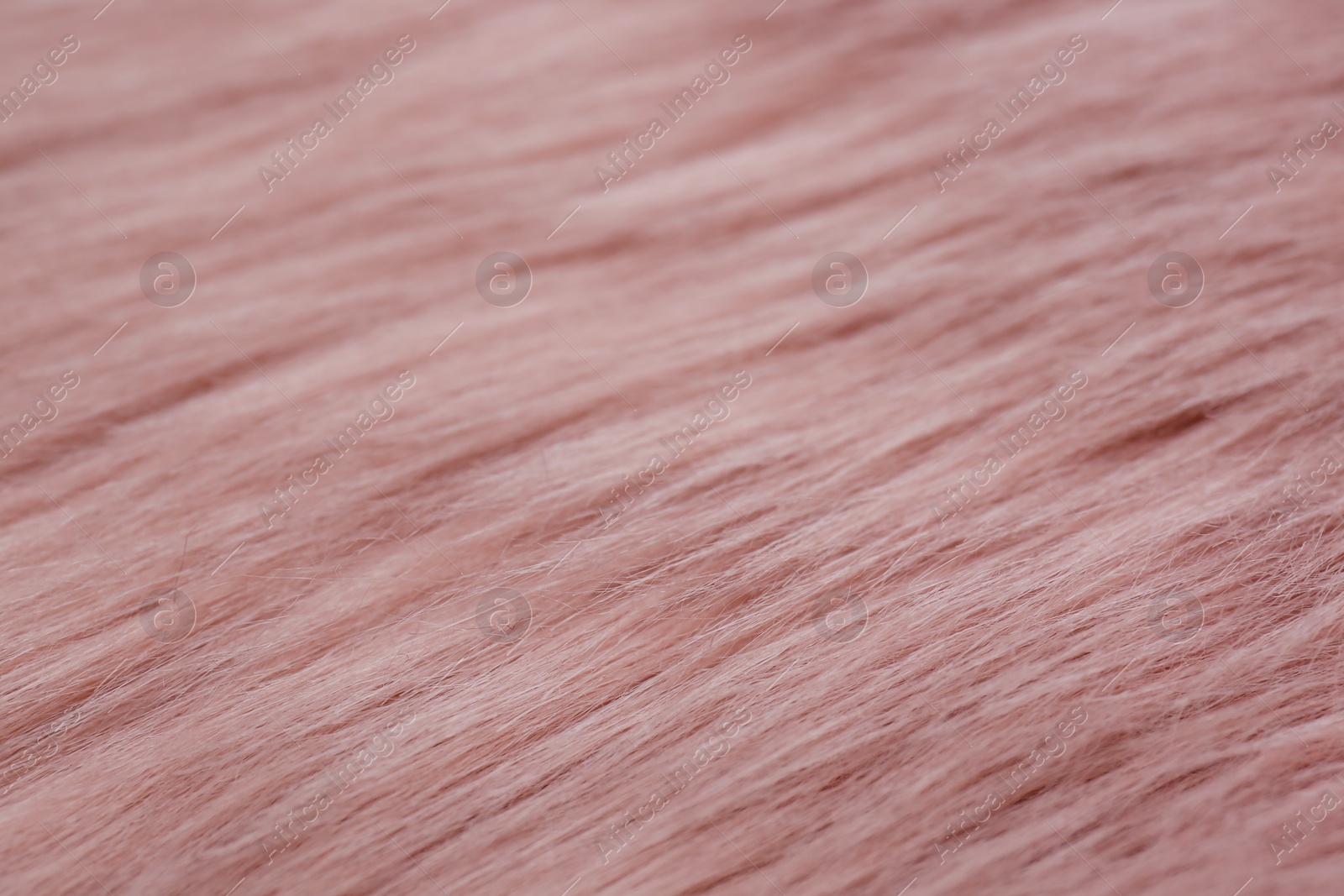 Photo of Pink faux fur as background, closeup view