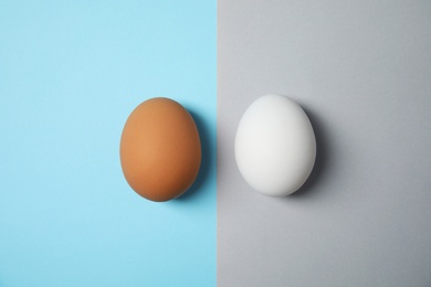 Photo of Raw chicken eggs on color background, top view