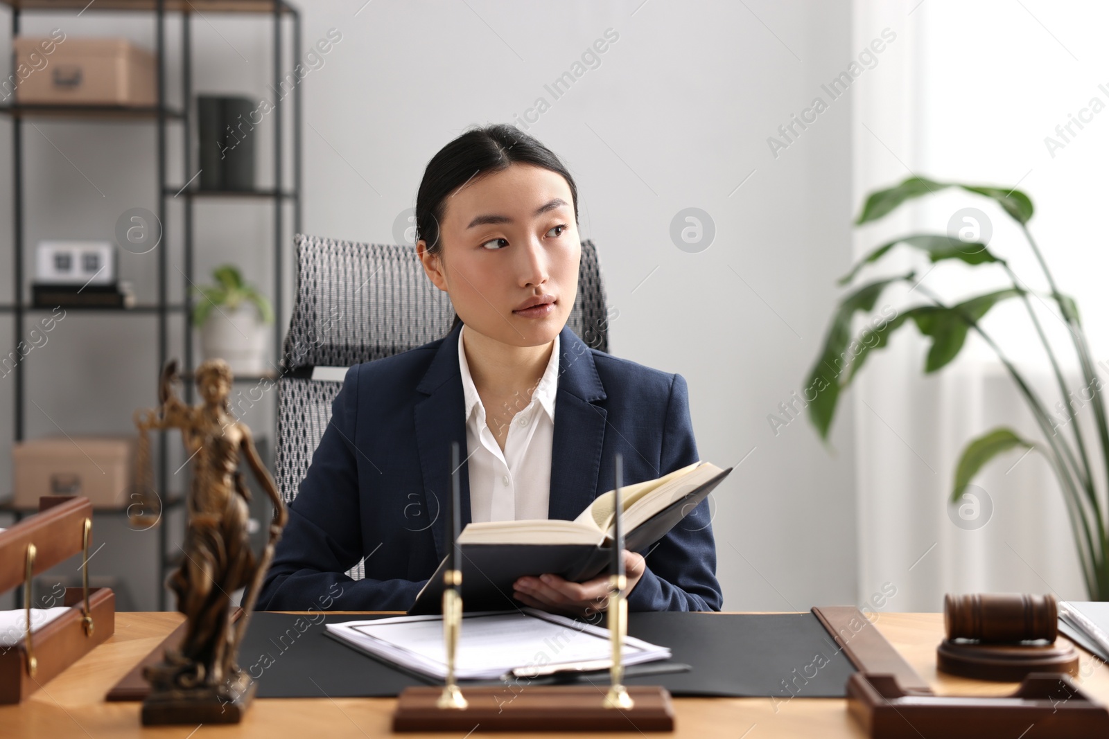 Photo of Notary with book at table in office