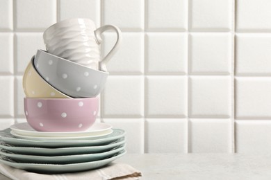 Photo of Beautiful ceramic dishware and cup on light grey table, space for text