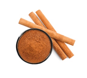 Aromatic cinnamon sticks and bowl with powder on white background, top view