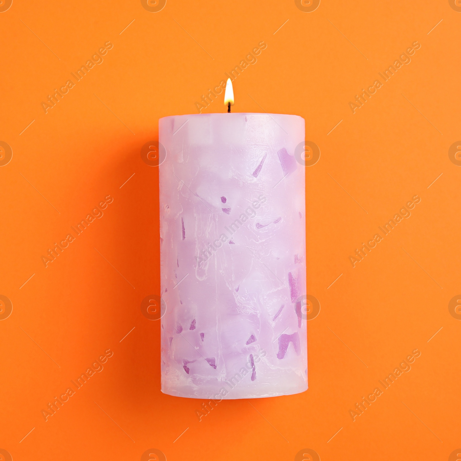 Photo of Alight scented wax candle on color background