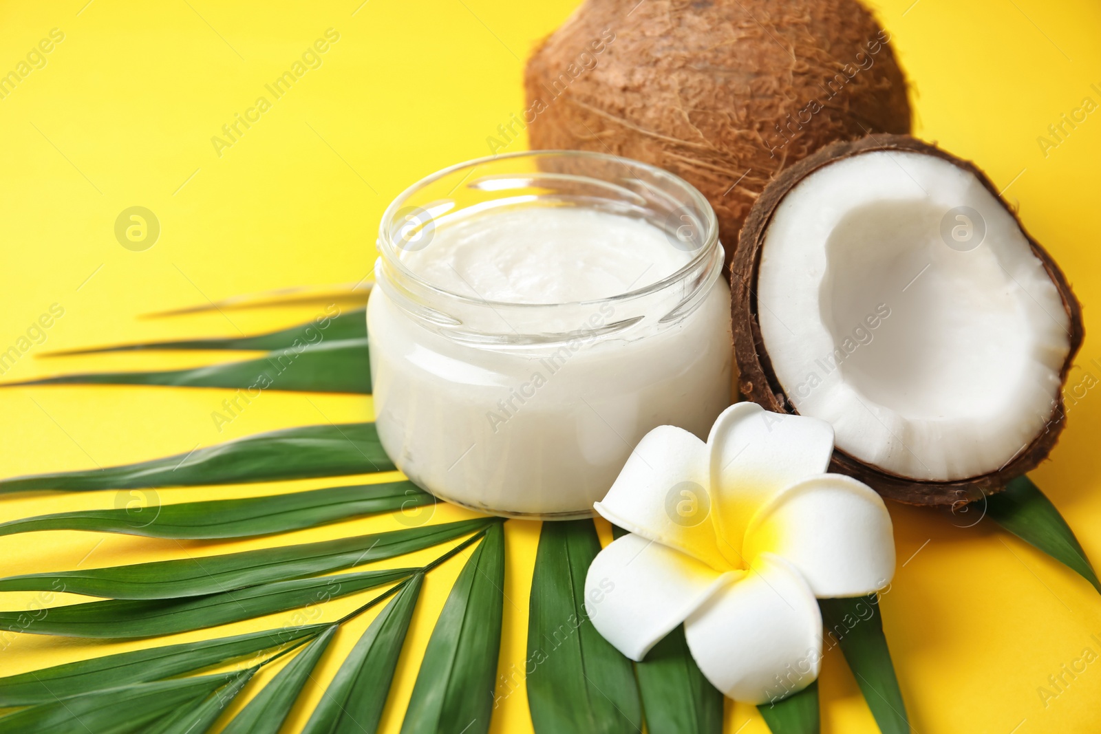 Photo of Beautiful composition with coconut oil and nuts on color background