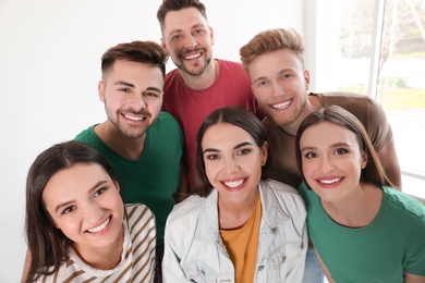 Photo of Group of happy people near window in room