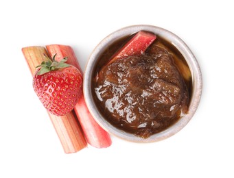 Photo of Tasty rhubarb jam in bowl, cut stems and strawberry on white background, top view