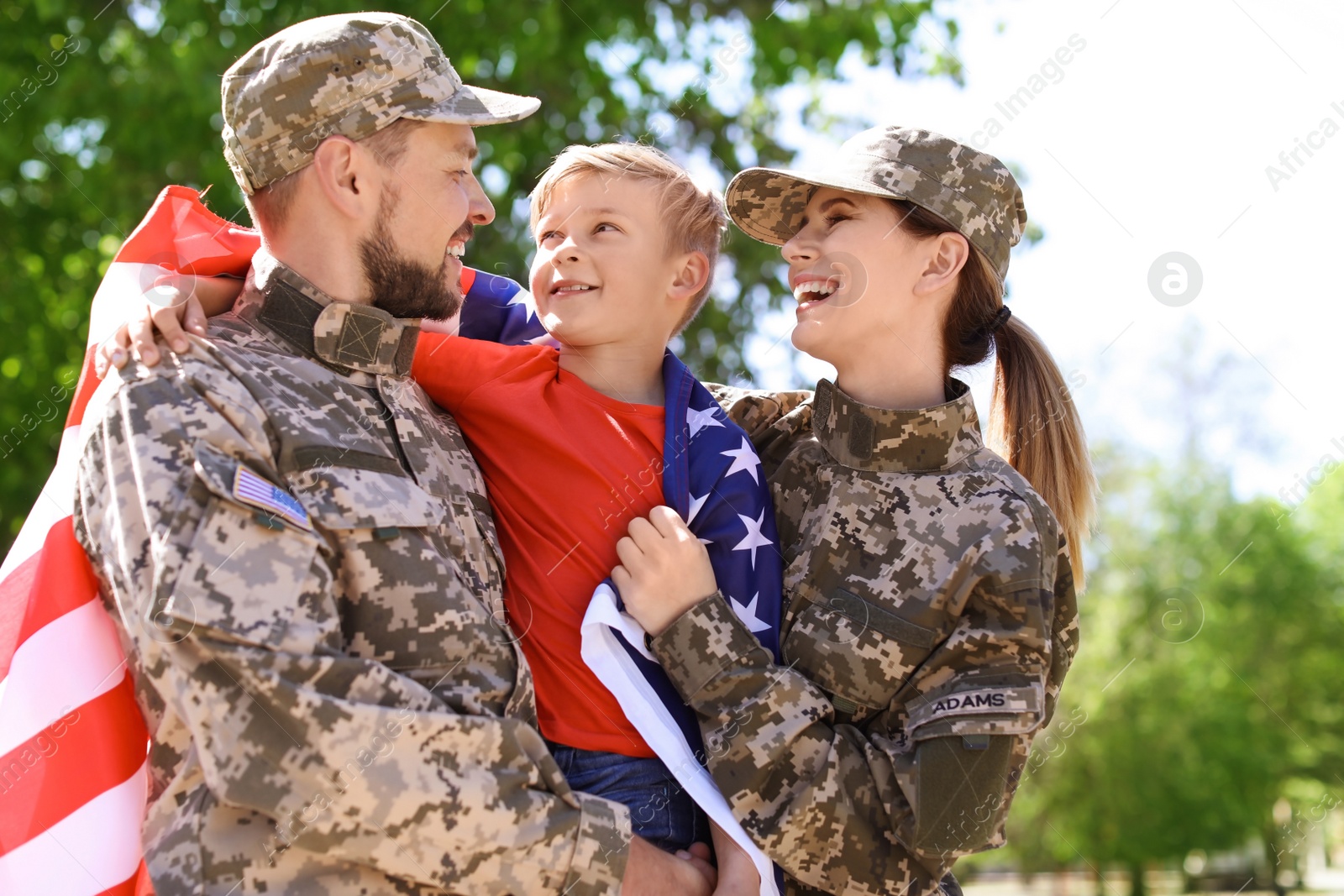 Photo of Happy military family with their son outdoors