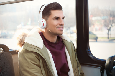 Photo of Man listening to audiobook in trolley bus