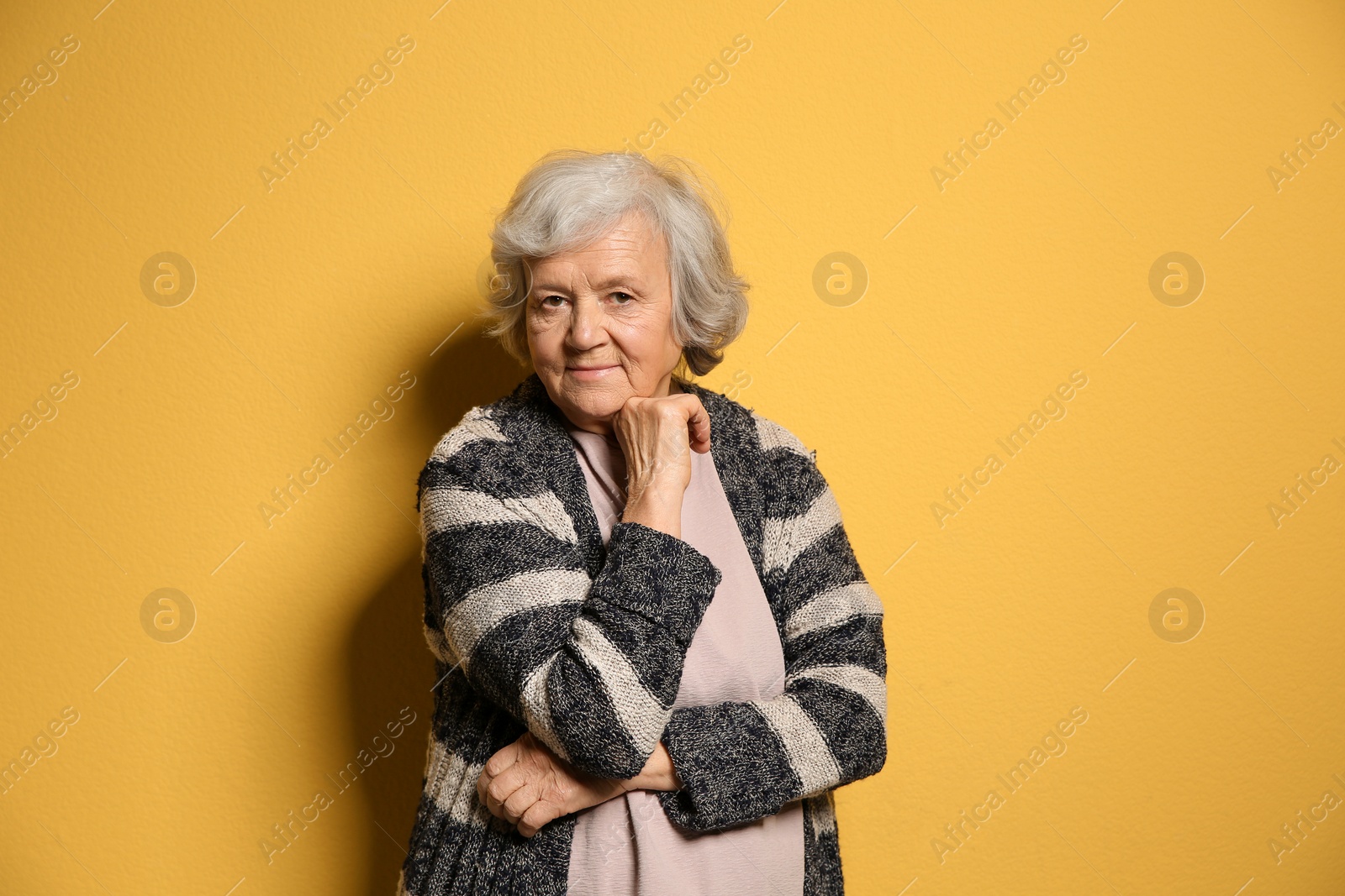 Photo of Portrait of elderly woman on color background