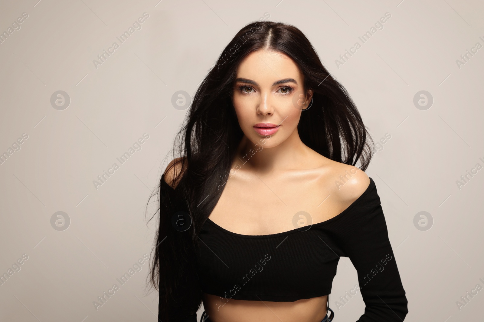 Photo of Portrait of beautiful young woman on light grey background