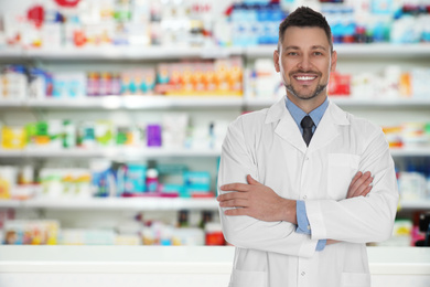 Professional pharmacist in modern drugstore, space for text 