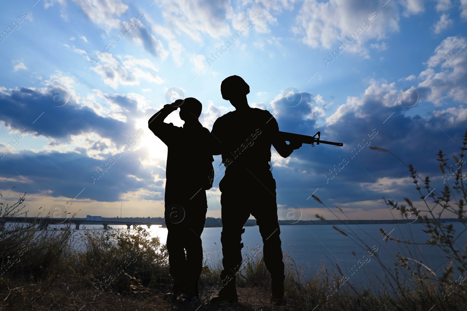 Photo of Soldiers in uniform patrolling outdoors. Military service