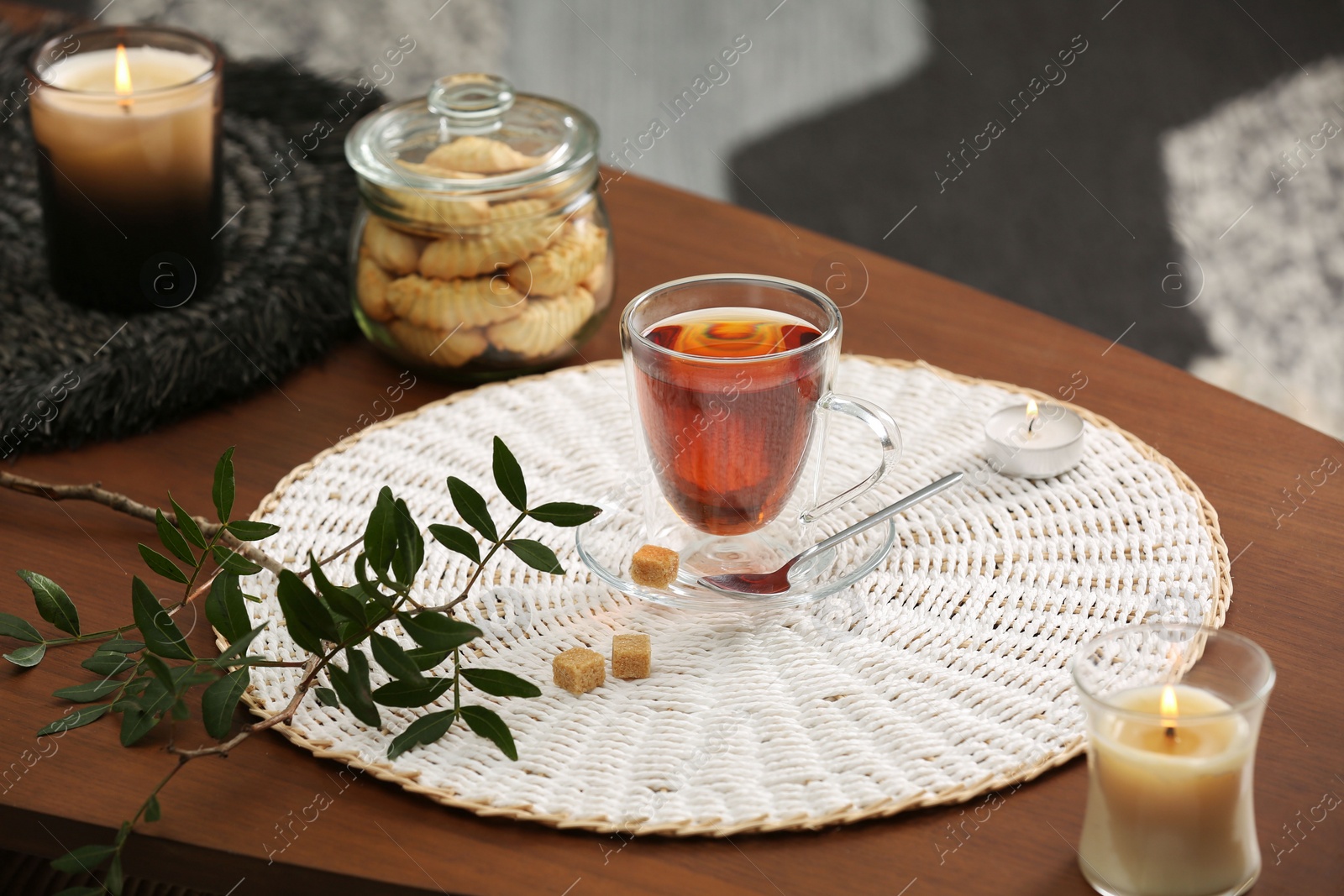 Photo of Tea, cookies and decorative elements on wooden table indoors