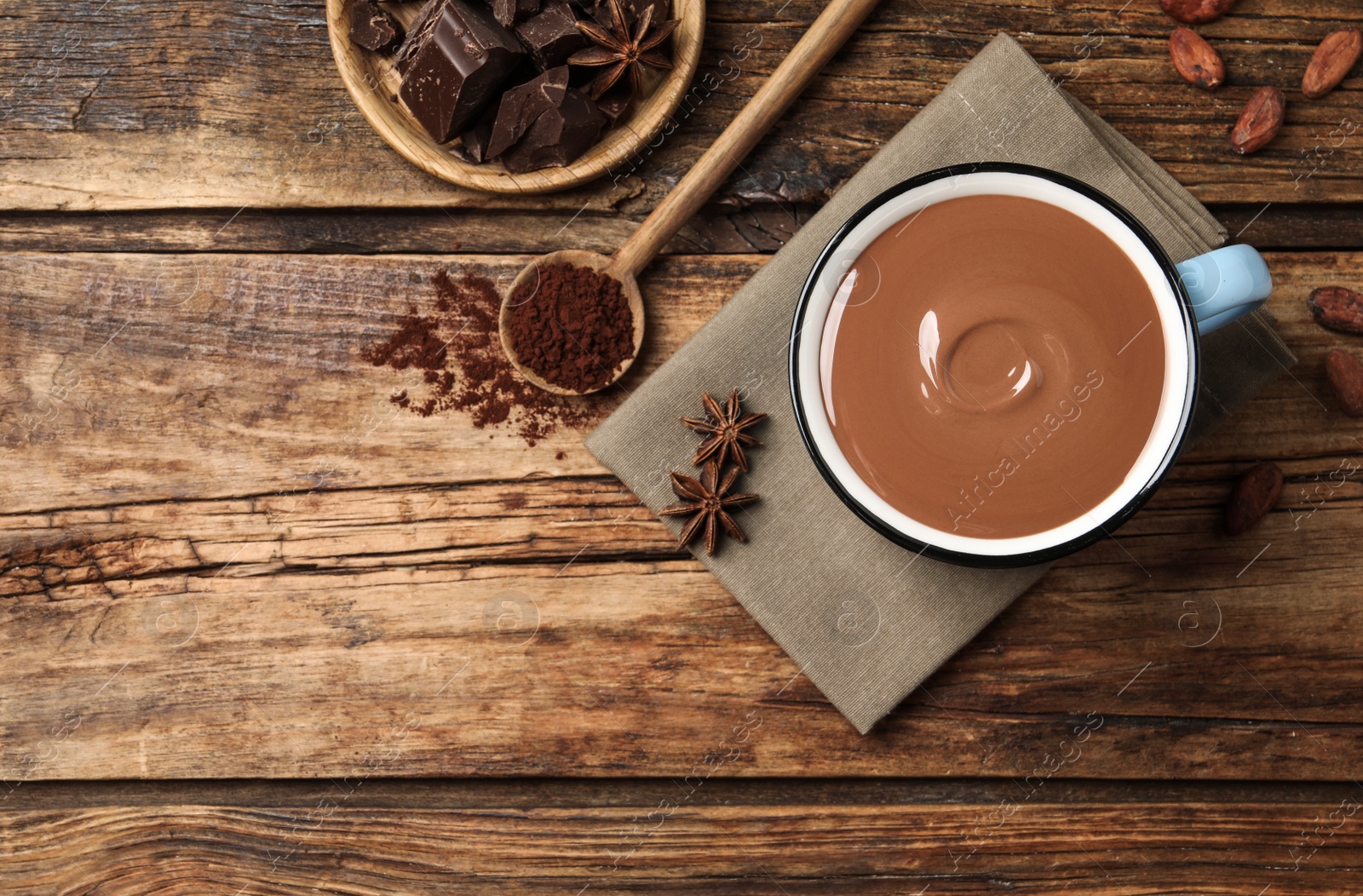 Photo of Flat lay composition with yummy hot chocolate on wooden table, space for text