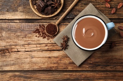 Flat lay composition with yummy hot chocolate on wooden table, space for text