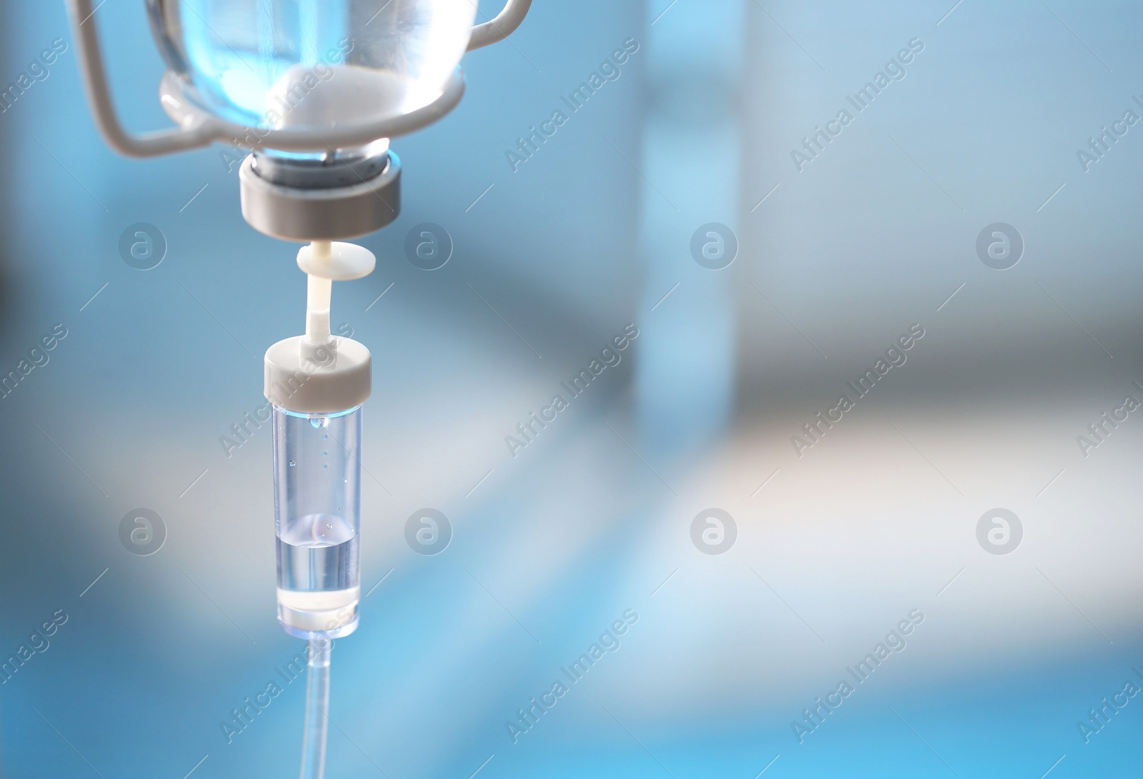 Photo of IV drip against blurred background, space for text