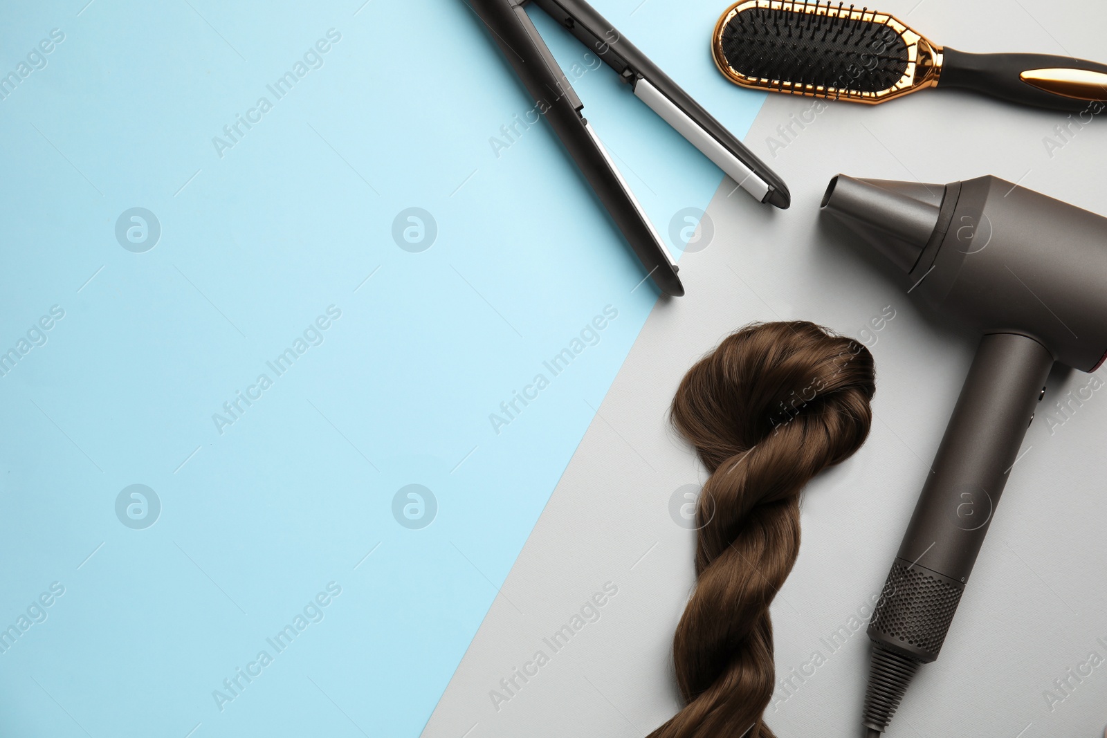 Photo of Flat lay composition with hairdressing equipment on color background. Space for text