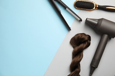 Flat lay composition with hairdressing equipment on color background. Space for text