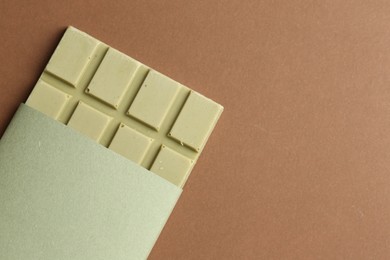 Tasty matcha chocolate bar on brown background, top view. Space for text