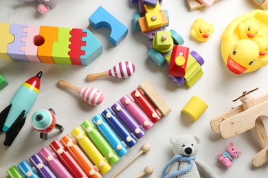 Photo of Different toys on light background, flat lay