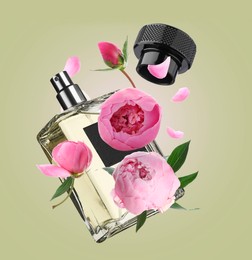 Bottle of perfume and peonies in air on olive background. Flower fragrance