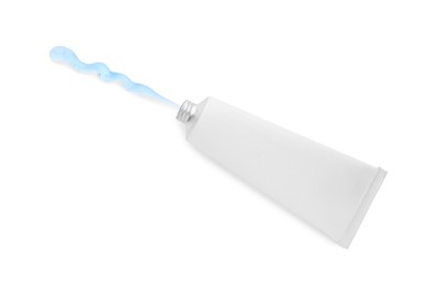 Photo of Open tube with ointment on white background, top view