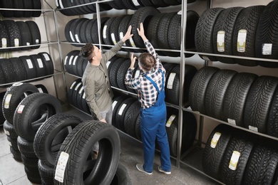 Photo of Service center consultant helping customer to choose tire in store