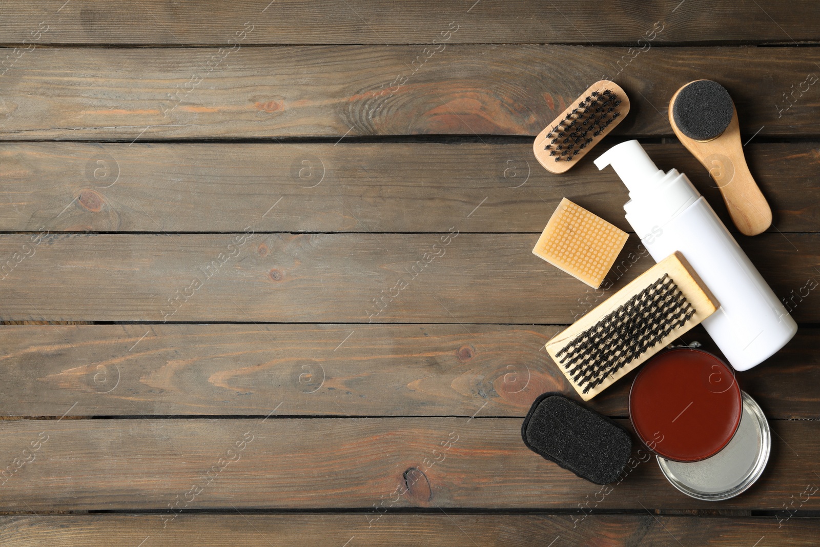 Photo of Flat lay composition with shoe care accessories on wooden background, space for text