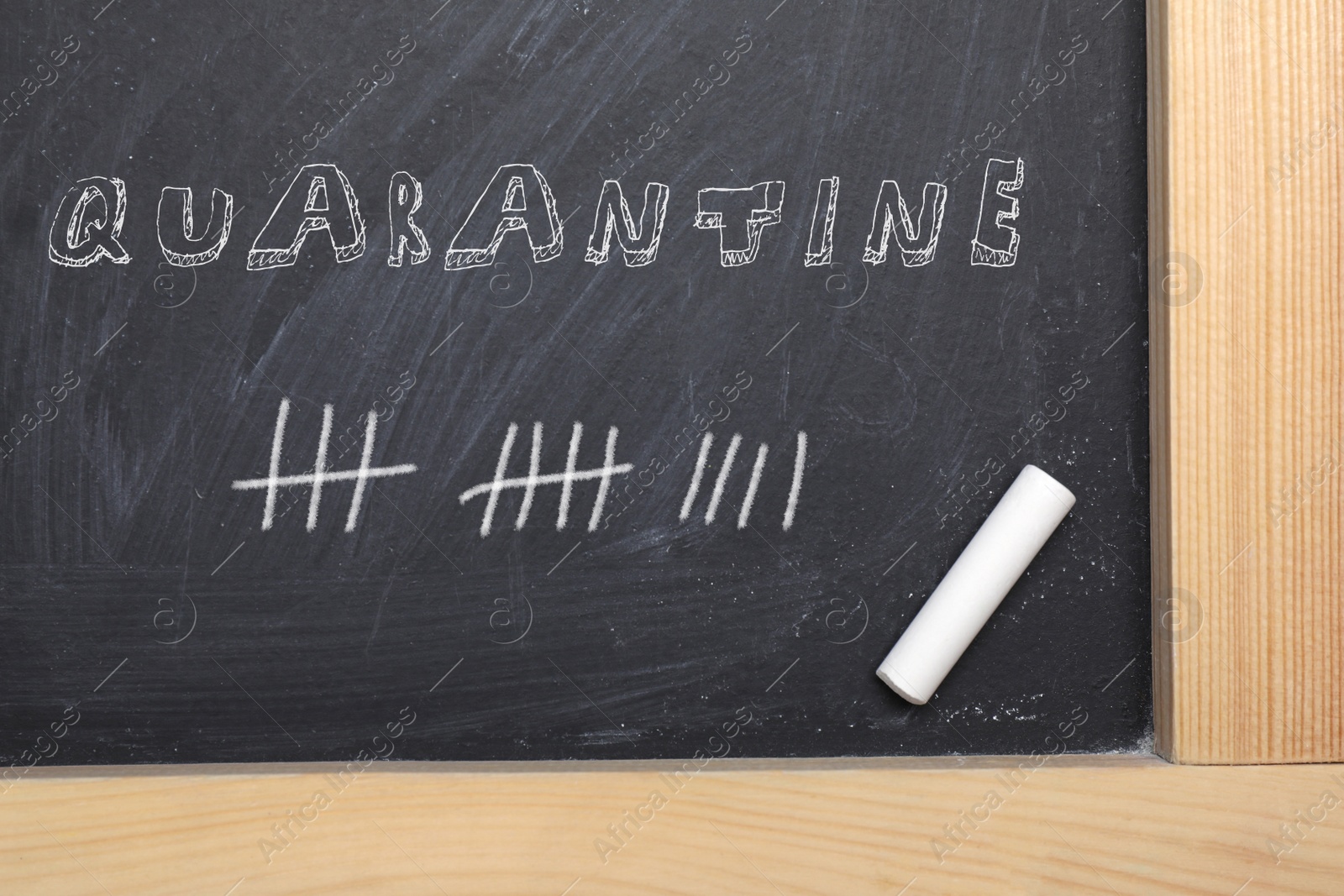 Image of Piece of white chalk on blackboard, top view. Counting days of quarantine during coronavirus outbreak 