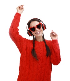 Photo of Young woman wearing heart shaped glasses listening to music on white background