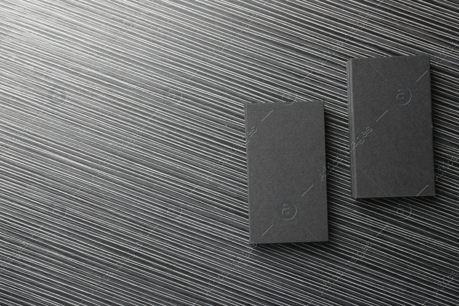 Photo of Blank black business cards on wooden table, top view. Mockup for design